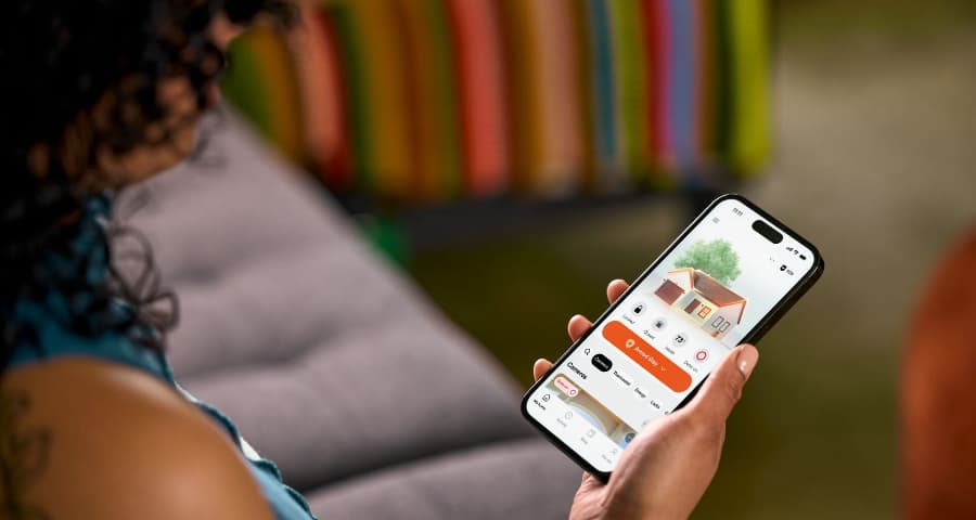 Customer checking the HomeView upgrade in the Vivint app to look at security, automation, and energy usage.